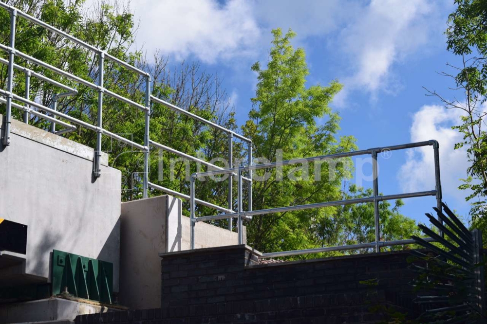 Railway bridge replacement project featuring guardrailing constructed with Interclamp key clamp fittings, providing essential safety for workers